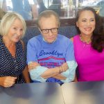 Larry King with two ladies